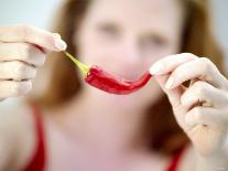 Woman Holding out a Red Chili Pepper-Maren Brinkmann-Photographic Print