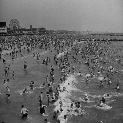 Huge Crowd Gathered in the Surf and at the Beach in Front of Coney Island Amusement Park