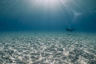 Solitary Scuba Diver in Shallow Sandy Bay, with Sun Beams, Naama Bay