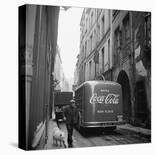 A Man Walks His Dog Beside a Bus with Coca Cola Advertisement, France, 1950-Mark Kauffman-Photographic Print