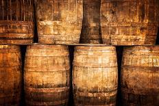 Detail Monochrome View of Stacked Wine and Whisky Wooden Barrels-MartinM303-Photographic Print