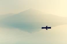 Fog over the Lake. Silhouette of Mountains in the Background. the Man Floats in a Boat with a Paddl-Maryna Patzen-Stretched Canvas