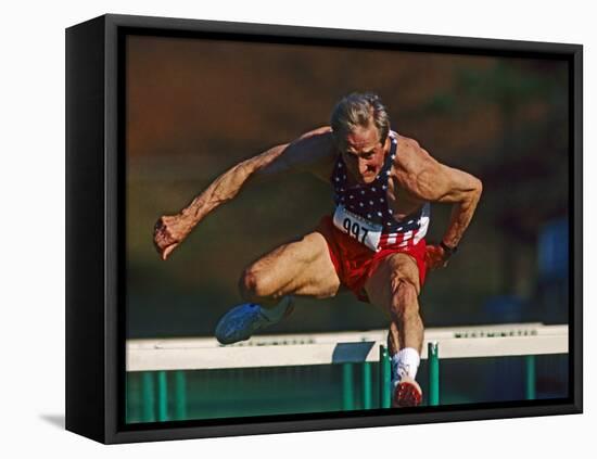 Mature Athlete Competes in Hurdles Race, Atlanta, Georgia, USA-Paul Sutton-Framed Stretched Canvas