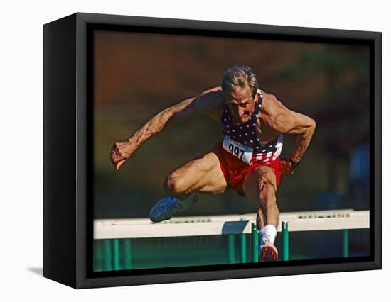 Mature Athlete Competes in Hurdles Race, Atlanta, Georgia, USA-Paul Sutton-Framed Stretched Canvas