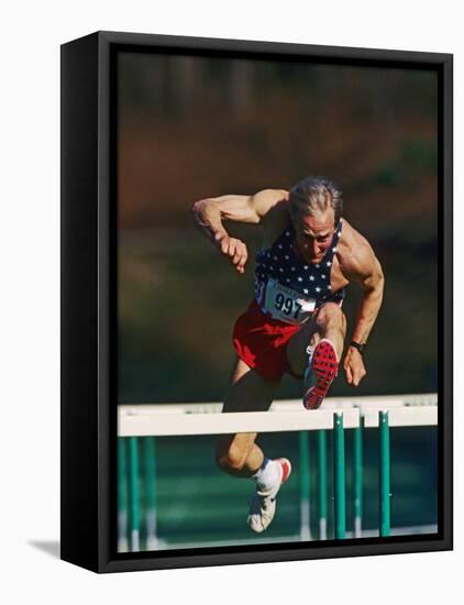Mature Athlete Competing in Hurdles Race, Atlanta, Georgia, USA-Paul Sutton-Framed Stretched Canvas