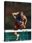 Mature Athlete Competing in Hurdles Race, Atlanta, Georgia, USA-Paul Sutton-Stretched Canvas