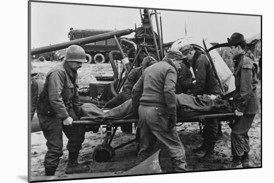 Medics Carry a Wounded U.S. Soldier Away from a Rescue Helicopter-null-Mounted Photo