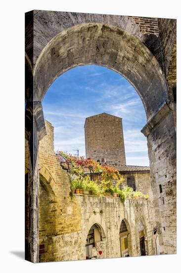 Medieval stone arch and tower, San Gimignano, Tuscany, Italy.-William Perry-Stretched Canvas