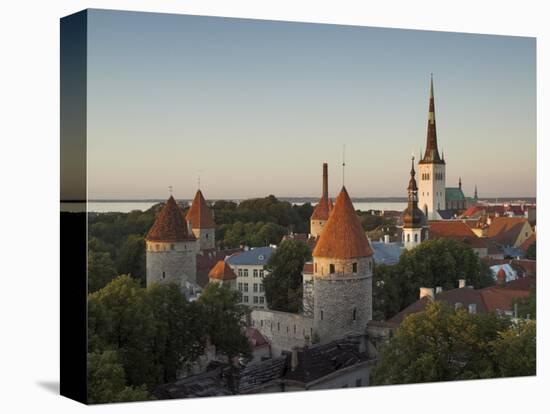 Medieval Town Walls and Spire of St. Olavs Church at Dusk, Tallinn, Estonia, Baltic States, Europe-Neale Clarke-Stretched Canvas