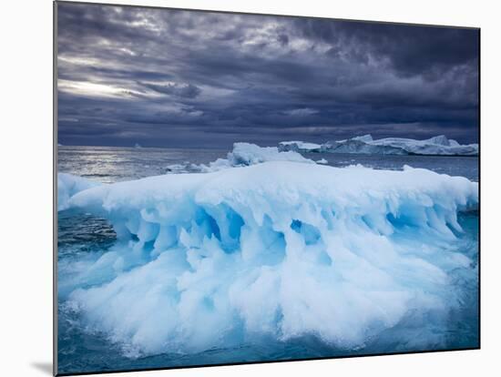 Melting Iceberg Floating Near Face of Jakobshavn Isfjord on Stormy Evening, Ilulissat, Greenland-Paul Souders-Mounted Photographic Print