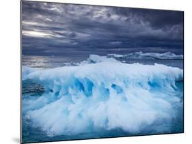 Melting Iceberg Floating Near Face of Jakobshavn Isfjord on Stormy Evening, Ilulissat, Greenland-Paul Souders-Mounted Photographic Print