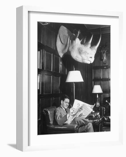 Member Reading Newspaper in Smoking Room at the Harvard Club Beneath a Rhino Head Trophy-Alfred Eisenstaedt-Framed Photographic Print