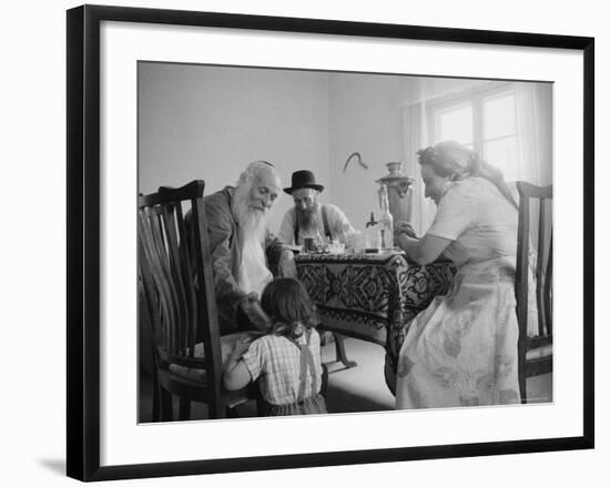 Members of a Jewish Family Sitting Down For a Meal-Paul Schutzer-Framed Photographic Print