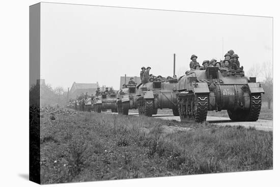Members of the British 49th Armoured Personnel Carrier Regiment Riding Along a Line of Tanks-George Silk-Stretched Canvas