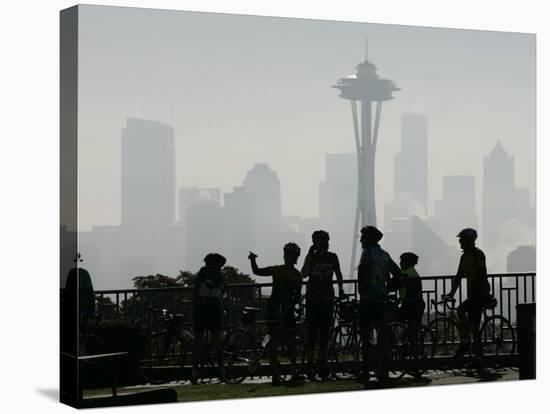 Members of the Cascade Bike Club Pause and Take in a Foggy View of the Space Needle-Ted S. Warren-Stretched Canvas