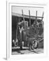 Men Constructing a Wheat Wreath Behind a Wheat Filled Wagon During the Harvest Season-Hans Wild-Framed Photographic Print