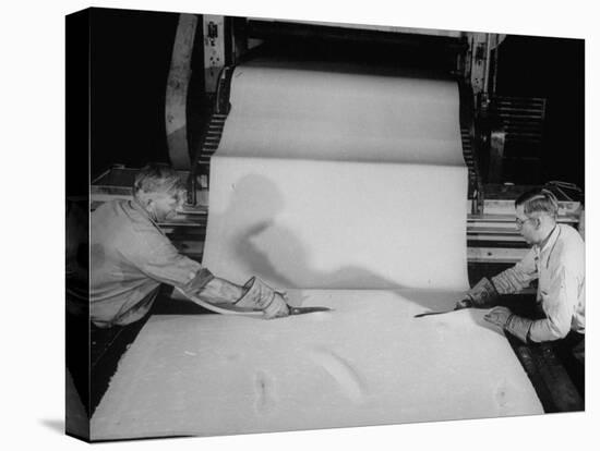 Men Cutting Sheet of Newly Manufactured Rubber-null-Stretched Canvas