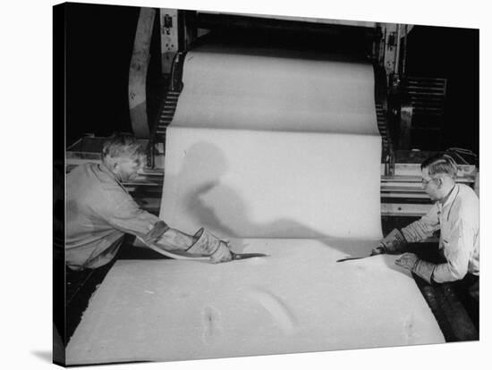 Men Cutting Sheet of Newly Manufactured Rubber-null-Stretched Canvas