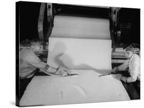 Men Cutting Sheet of Newly Manufactured Rubber-null-Stretched Canvas