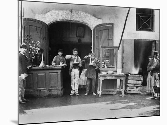 Men Eating Long Spaghetti at a Street Food Shop in Naples, Italy, Ca. 1900-null-Mounted Photo