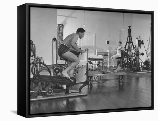 Men Exercising in Gymnasium at Homestead Hotel-John Phillips-Framed Stretched Canvas
