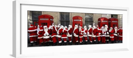 Men from the London Santa School, Dressed in Christmas Outfits, Pose by Telephone Boxes in London-null-Framed Photographic Print