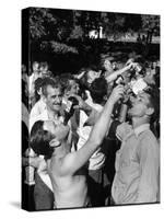 Men Having a Beer Drinking Contest at the Company Picnic-Allan Grant-Stretched Canvas