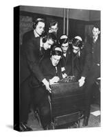 Men Huddled Around Telegraph Transmitter During Training by Federal Vocational Board-null-Stretched Canvas