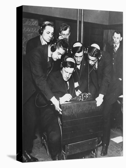 Men Huddled Around Telegraph Transmitter During Training by Federal Vocational Board-null-Stretched Canvas