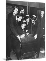 Men Huddled Around Telegraph Transmitter During Training by Federal Vocational Board-null-Mounted Photographic Print