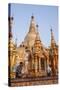 Men Laying Out Oil Lamps for Evening Ceremony at Buddhist Temple-Stephen Studd-Stretched Canvas