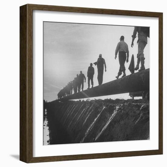 Men Laying Pipeline-null-Framed Photographic Print