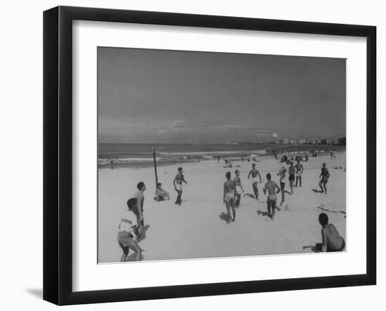 Men Playing a Game of Volleyball on the Beach-null-Framed Photographic Print