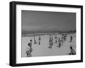 Men Playing a Game of Volleyball on the Beach-null-Framed Photographic Print