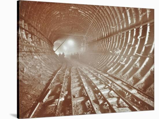 Men Pushing Railway Trucks Along the Rotherhithe Tunnel, Stepney, London, June 1907-null-Stretched Canvas