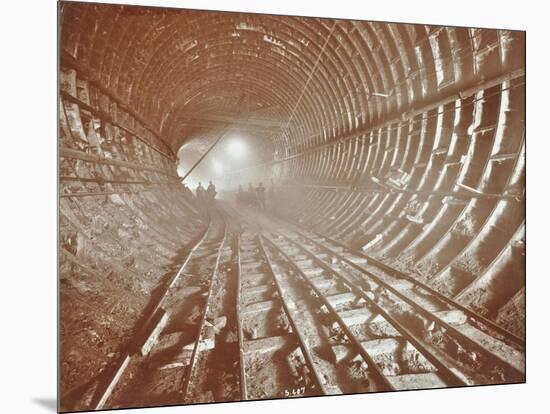 Men Pushing Railway Trucks Along the Rotherhithe Tunnel, Stepney, London, June 1907-null-Mounted Photographic Print