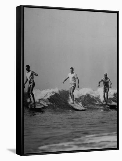 Men Riding the Waves on Surf Boards-null-Framed Stretched Canvas