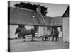 Men Standing Near Horse-Drawn Farming Equipment-null-Stretched Canvas