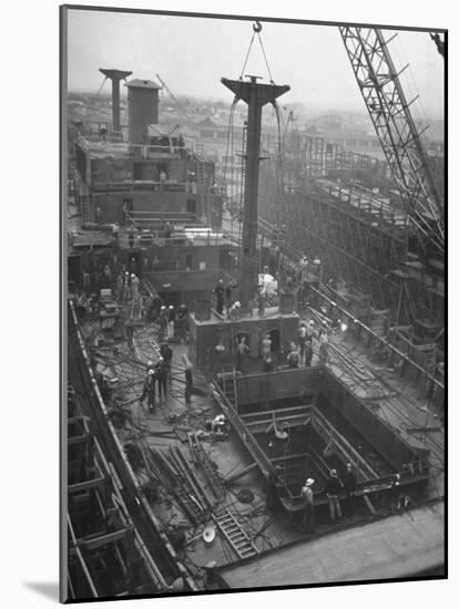 Men Working on the Liberty Ship in the Kaiser Shipyard-Hansel Mieth-Mounted Photographic Print