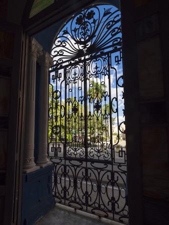 Cuba, Camaguey, UNESCO World Heritage Site, wrought iron grill in giant window of colonial mansion