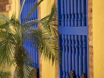 Woman Exits thru Moorish-Style Blue Door, Morocco-Merrill Images-Photographic Print