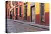 Mexico, San Miguel de Allende. Elderly man walks up sidewalk.-Don Paulson-Stretched Canvas