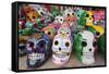 Mexico, Yucatan, Isla Mujeres, colorful ceramic calavera skulls for sale in market.-Merrill Images-Framed Stretched Canvas