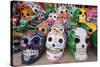 Mexico, Yucatan, Isla Mujeres, colorful ceramic calavera skulls for sale in market.-Merrill Images-Stretched Canvas