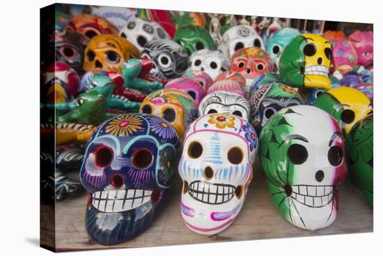 Mexico, Yucatan, Isla Mujeres, colorful ceramic calavera skulls for sale in market.-Merrill Images-Stretched Canvas