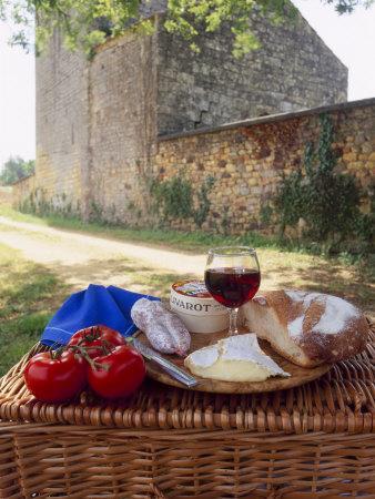 Picnic Lunch of Bread, Cheese, Tomatoes and Red Wine on a Hamper in the Dordogne, France
