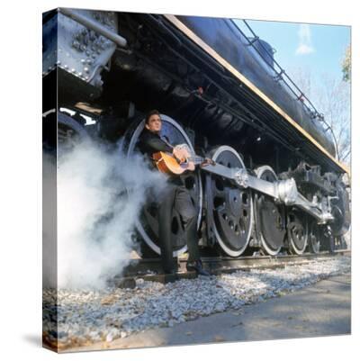 Country/Western Singer Johnny Cash W. Guitar by Wheels of a Steam Train