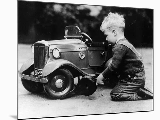 Michael Ware Repairing a Pedal Car-null-Mounted Photographic Print