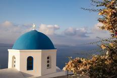 Blue domed Greek Orthodox church with bougainvillea flowers in Oia, Santorini, Greece.-Michele Niles-Photographic Print