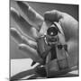 Micro Camera Resting in Palm of Hand-Andreas Feininger-Mounted Photographic Print